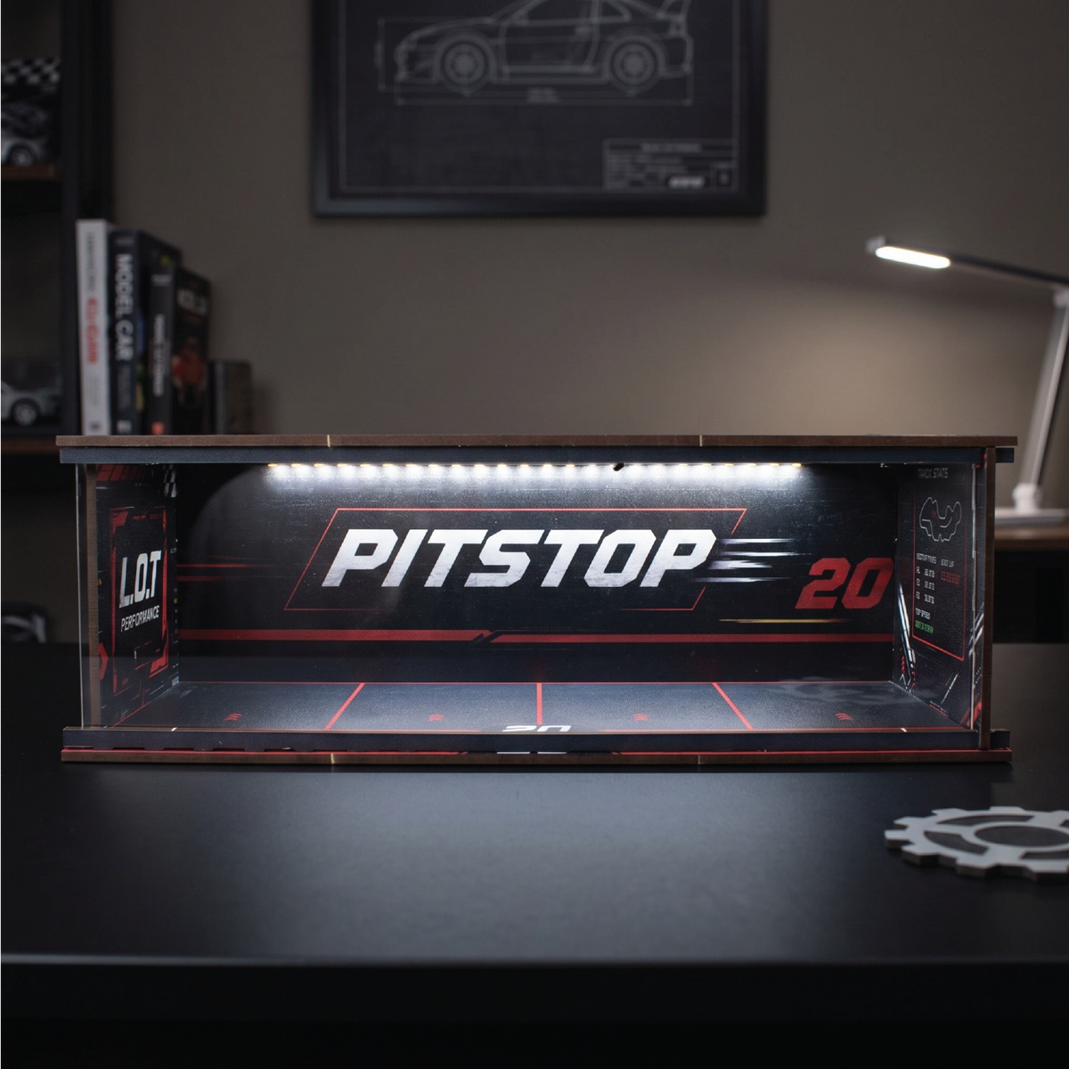 Pitstop 20 wooden display garage lit by its LED strip on a desk at night