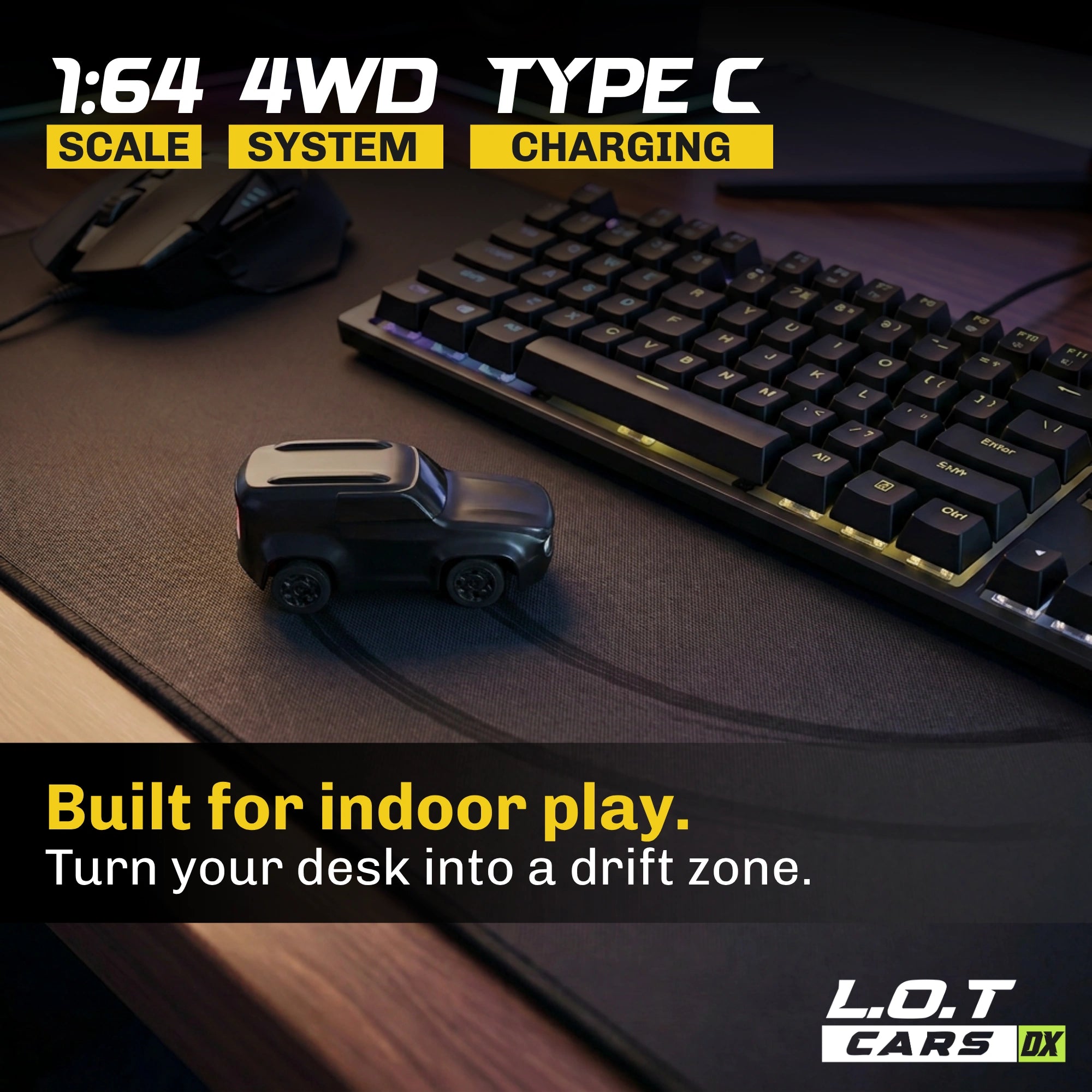 Small RC car on a desk with a keyboard, mouse, and text about 1:64 scale 4WD system.