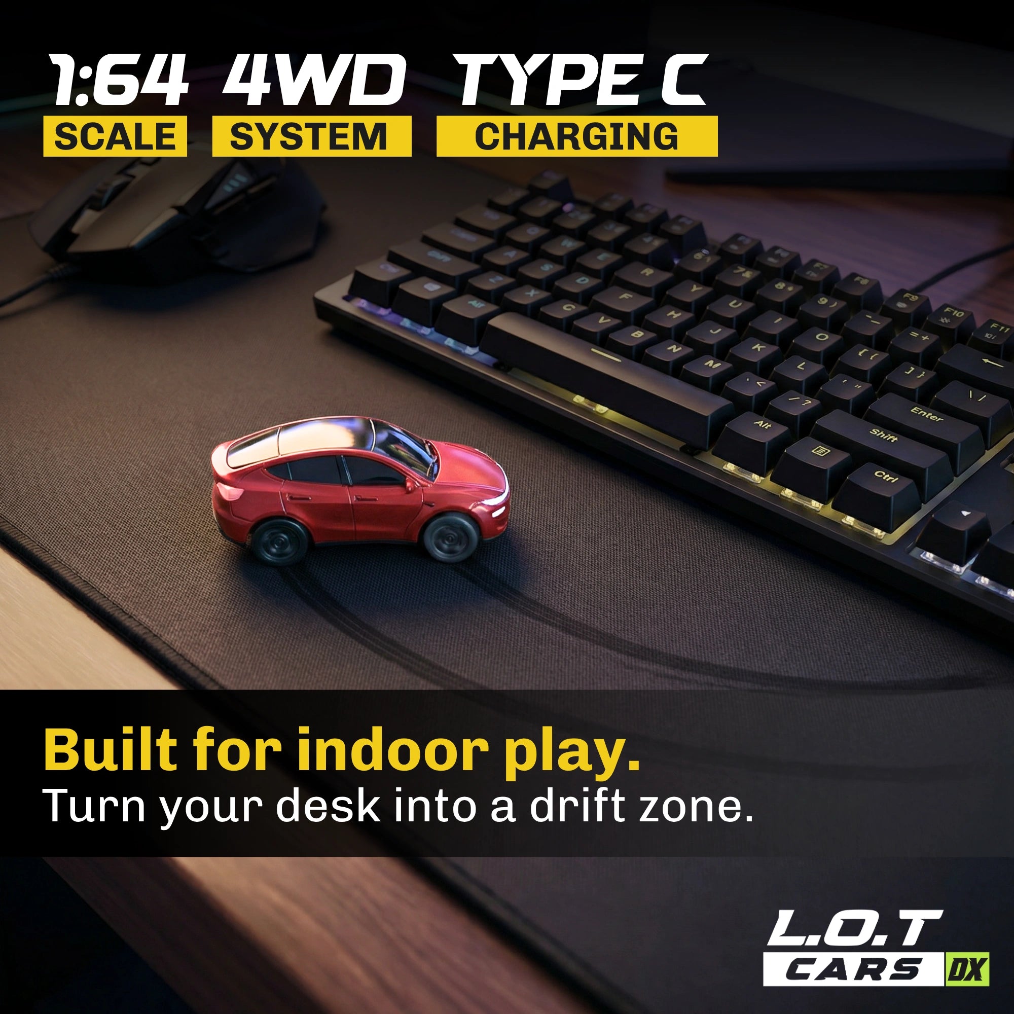 Small red RC car on a desk with keyboard and mouse, featuring text about scale, system, and charging.