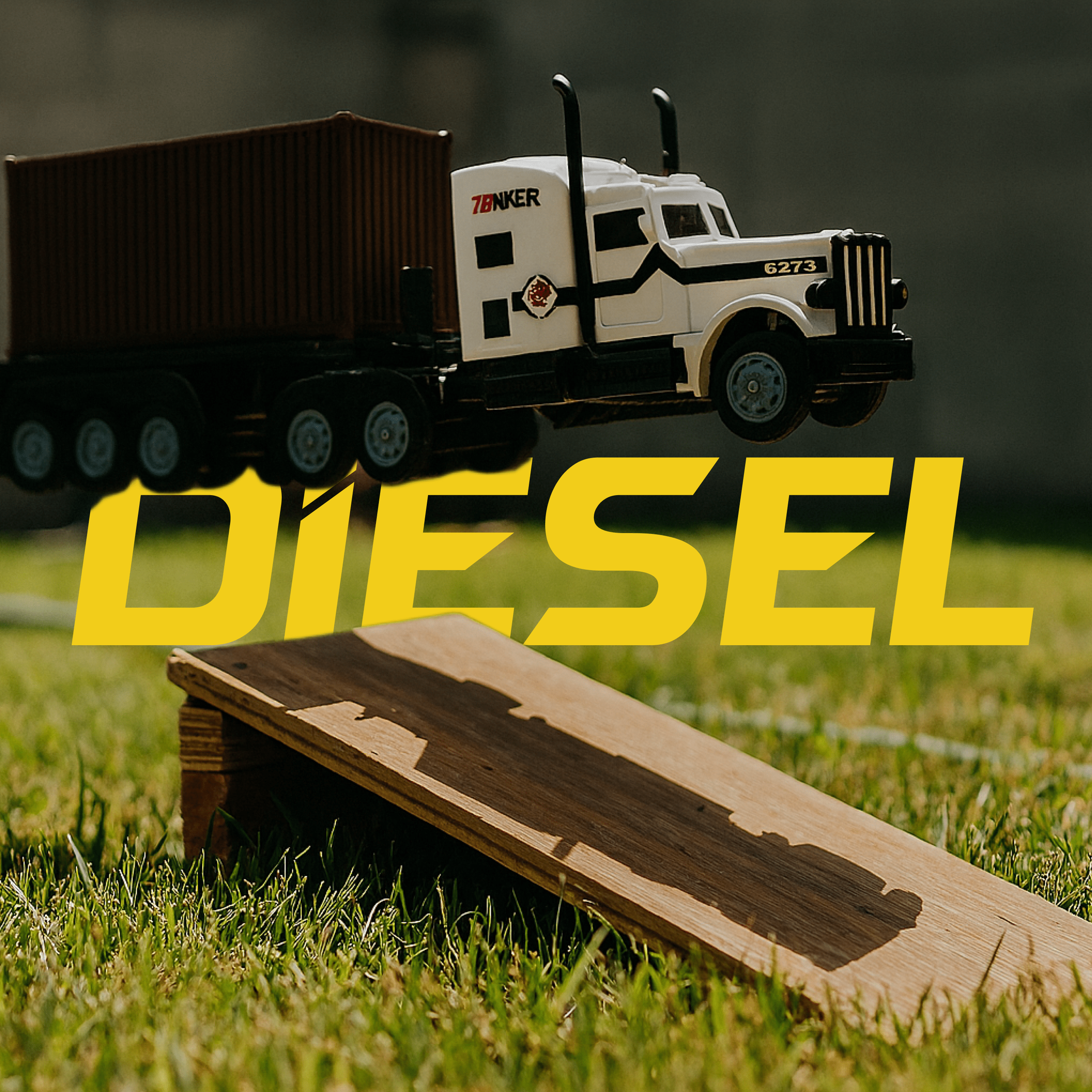 White RC Model truck with trailer on grass, 'DIESEL' text overlay