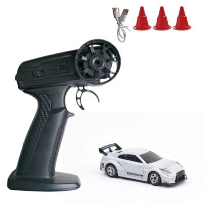 Black remote control transmitter with a white RC car and three red cones on a white background