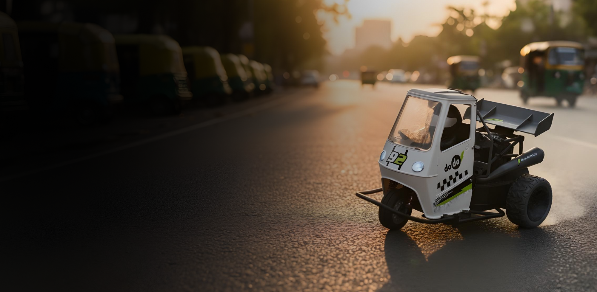 Small RC vehicle on a road with larger similar vehicles in the background