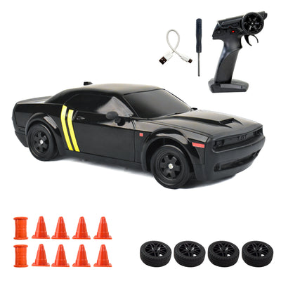 Black RC car with remote control, cones, and spare wheels on a white background